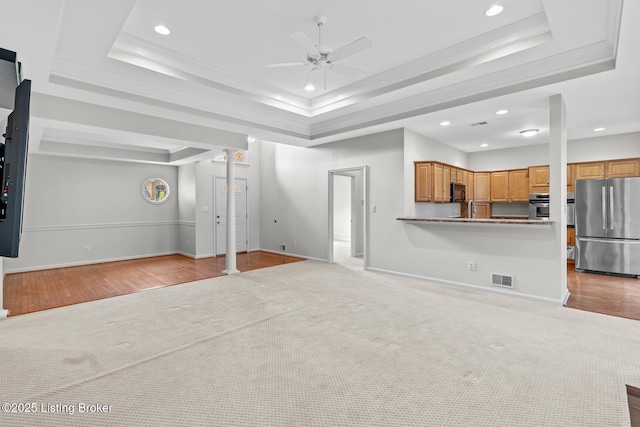 10121 Cave Creek Rd, Louisville, KY 40223 - unfurnished living room featuring a tray ceiling, light carpet, ceiling fan, recessed lighting, and crown molding