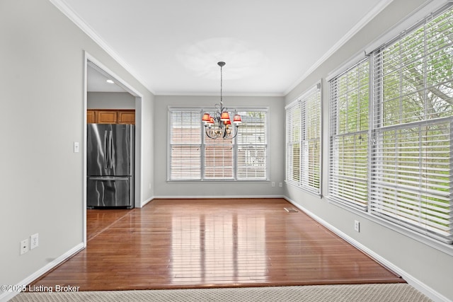 10121 Cave Creek Rd, Louisville, KY 40223 - unfurnished dining area with a chandelier, plenty of natural light, baseboards, and crown molding