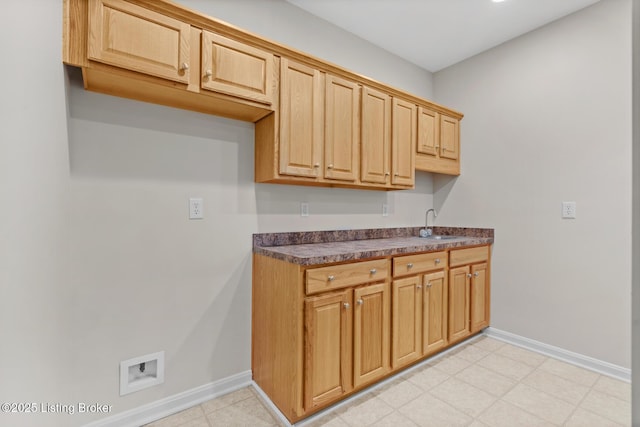 10121 Cave Creek Rd, Louisville, KY 40223 - kitchen featuring dark countertops, baseboards, and a sink