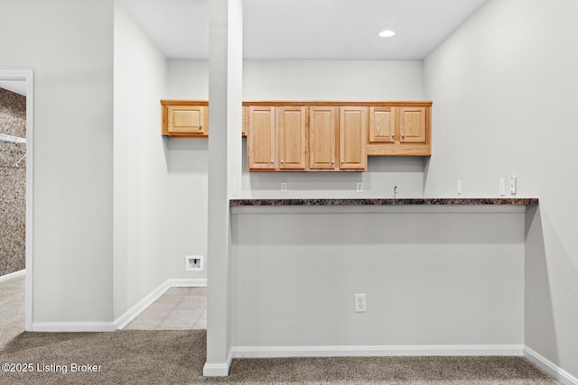 10121 Cave Creek Rd, Louisville, KY 40223 - kitchen with light colored carpet, dark countertops, and baseboards
