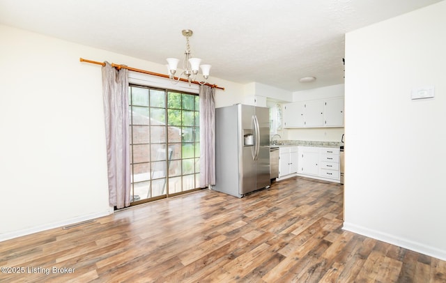 112 Bivins Ct, Radcliff, KY 40160 - kitchen with appliances with stainless steel finishes, a chandelier, light wood-style floors, white cabinetry, and a sink