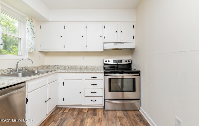 112 Bivins Ct, Radcliff, KY 40160 - kitchen with appliances with stainless steel finishes, under cabinet range hood, a sink, white cabinetry, and dark wood-style flooring
