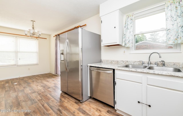 112 Bivins Ct, Radcliff, KY 40160 - kitchen with appliances with stainless steel finishes, a sink, a chandelier, light wood-style floors, and white cabinets