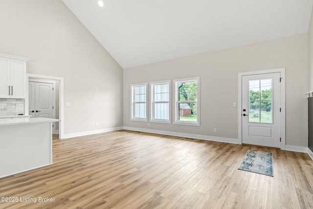 5311 Lee Ave, Crestwood, KY 40014 - unfurnished living room with high vaulted ceiling, plenty of natural light, light wood-style floors, and baseboards