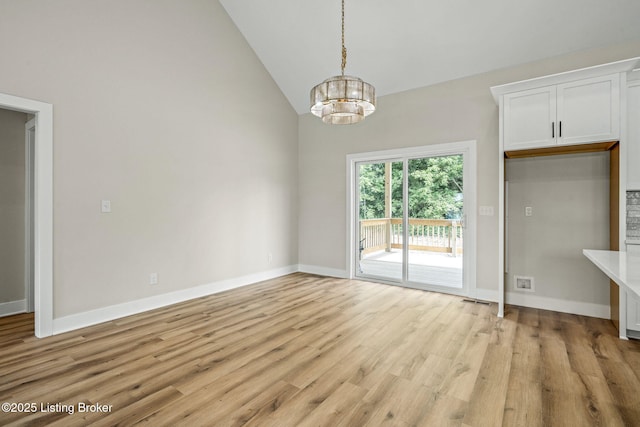 5311 Lee Ave, Crestwood, KY 40014 - unfurnished dining area featuring a chandelier, lofted ceiling, light wood-style flooring, and baseboards
