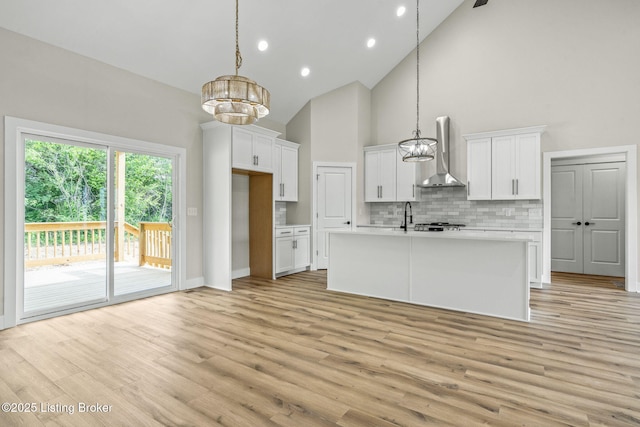 5311 Lee Ave, Crestwood, KY 40014 - kitchen with wall chimney exhaust hood, a chandelier, high vaulted ceiling, decorative backsplash, and light wood-style flooring