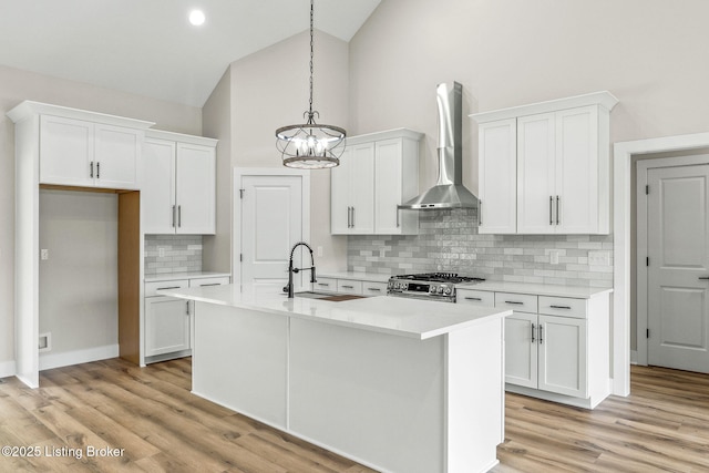 5311 Lee Ave, Crestwood, KY 40014 - kitchen featuring wall chimney exhaust hood, stainless steel gas range oven, a sink, white cabinetry, and backsplash