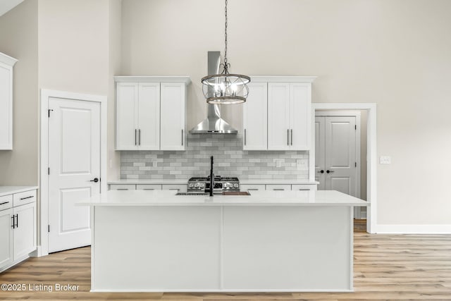 5311 Lee Ave, Crestwood, KY 40014 - kitchen featuring tasteful backsplash, light countertops, hanging light fixtures, light wood finished floors, and a towering ceiling