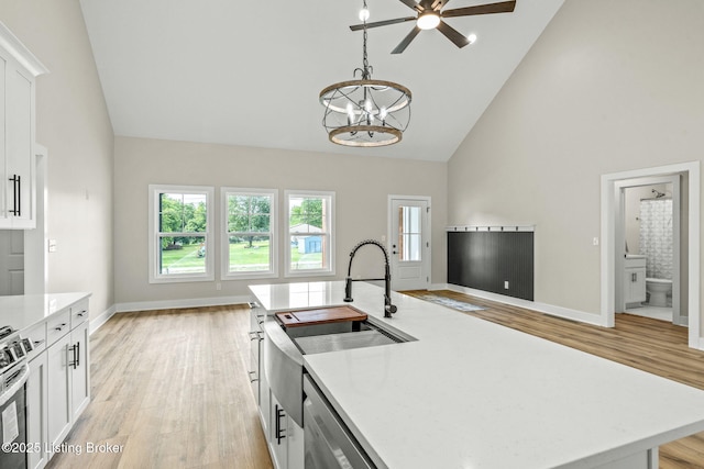 5311 Lee Ave, Crestwood, KY 40014 - kitchen featuring high vaulted ceiling, a chandelier, light wood-type flooring, white cabinets, and baseboards