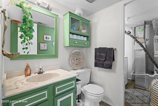 3104 Valleyside Ct, Louisville, KY 40214 - bathroom with a textured ceiling, vanity, toilet, baseboards, and heating unit