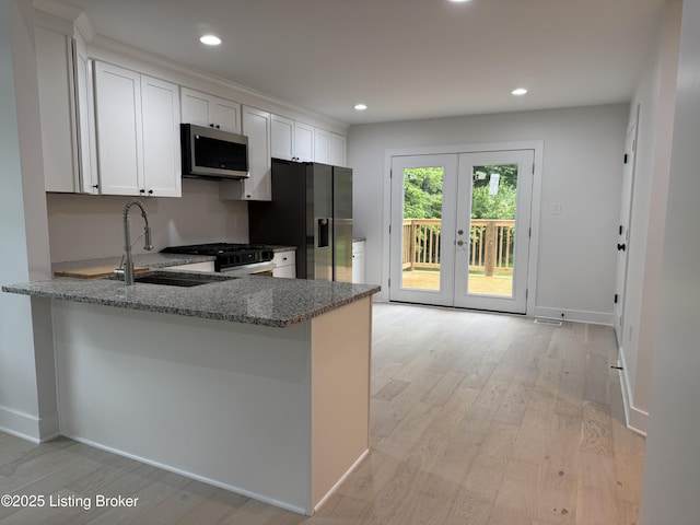 6702 Shirley Ave, Prospect, KY 40059 - kitchen featuring stainless steel appliances, a sink, french doors, light stone countertops, and a peninsula