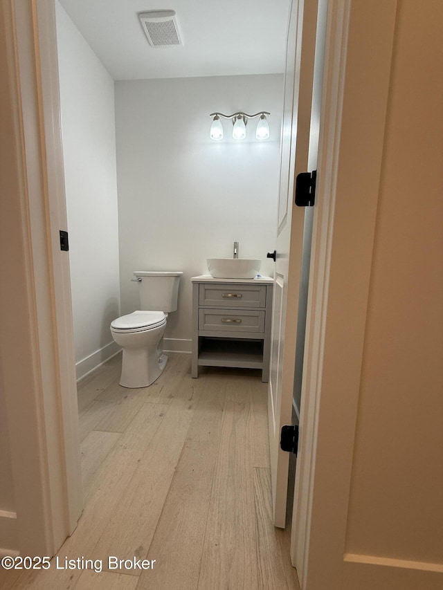 6702 Shirley Ave, Prospect, KY 40059 - half bathroom with wood finished floors, vanity, toilet, and baseboards