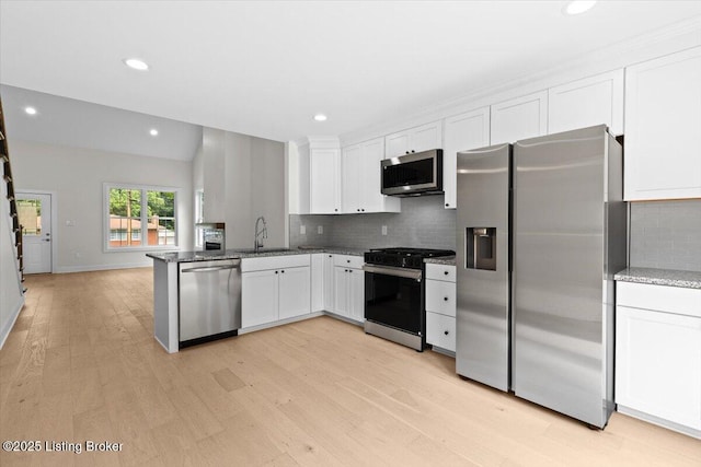 6702 Shirley Ave, Louisville, KY 40059 - kitchen featuring stainless steel appliances, a sink, light wood-style floors, white cabinetry, and backsplash