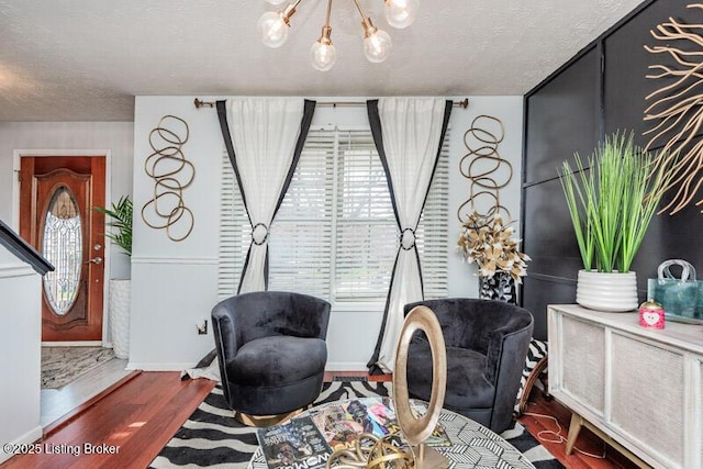 9505 River Trail Dr, Louisville, KY 40229 - sitting room with wood finished floors, a textured ceiling, and a chandelier