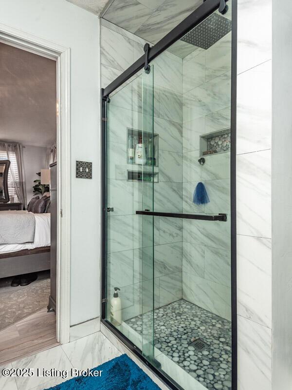 9505 River Trail Dr, Louisville, KY 40229 - ensuite bathroom with a shower stall and marble look tile flooring