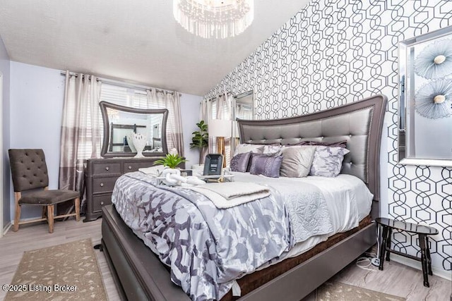 9505 River Trail Dr, Louisville, KY 40229 - bedroom with wood finished floors, wallpapered walls, baseboards, and a chandelier