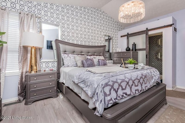 9505 River Trail Dr, Louisville, KY 40229 - bedroom featuring baseboards, a chandelier, a barn door, and wallpapered walls