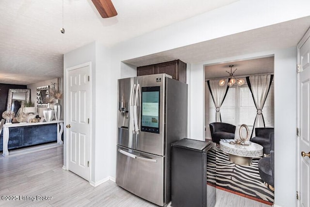 9505 River Trail Dr, Louisville, KY 40229 - kitchen with stainless steel fridge with ice dispenser, light wood-style floors, open floor plan, and a chandelier