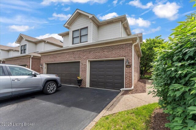 3447 Hurstbourne Ridge Blvd, Louisville, KY 40299 - view of front of property with a garage, brick siding, and driveway