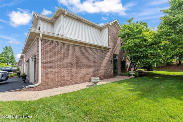 3447 Hurstbourne Ridge Blvd, Louisville, KY 40299 - view of side of property featuring brick siding, a lawn, an attached garage, and asphalt driveway