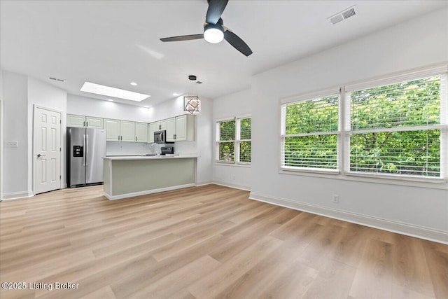 3447 Hurstbourne Ridge Blvd, Louisville, KY 40299 - kitchen with stainless steel appliances, light wood-style floors, a skylight, baseboards, and a peninsula