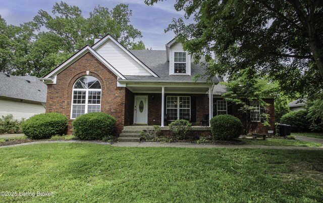512 Valley College Dr, Louisville, KY 40272 - view of front of home with a front yard, a porch, brick siding, roof with shingles, and a chimney