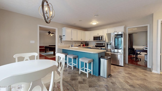 512 Valley College Dr, Louisville, KY 40272 - kitchen featuring appliances with stainless steel finishes, a sink, light stone finish floors, light countertops, and white cabinetry