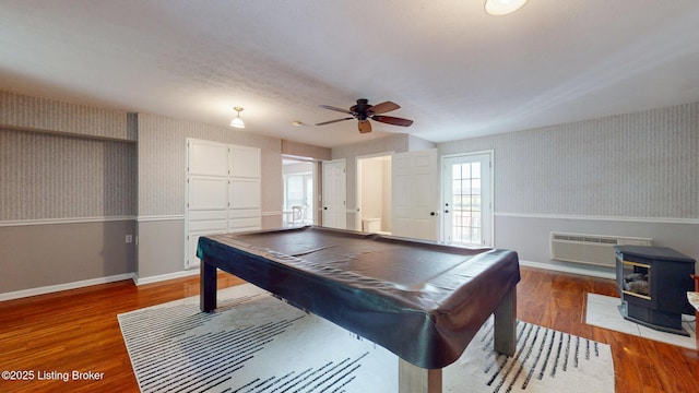 512 Valley College Dr, Louisville, KY 40272 - rec room with wallpapered walls, a wood stove, ceiling fan, baseboards, and wood finished floors