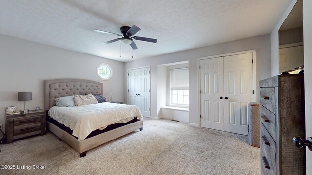 512 Valley College Dr, Louisville, KY 40272 - bedroom featuring two closets, carpet, a ceiling fan, baseboards, and a textured ceiling