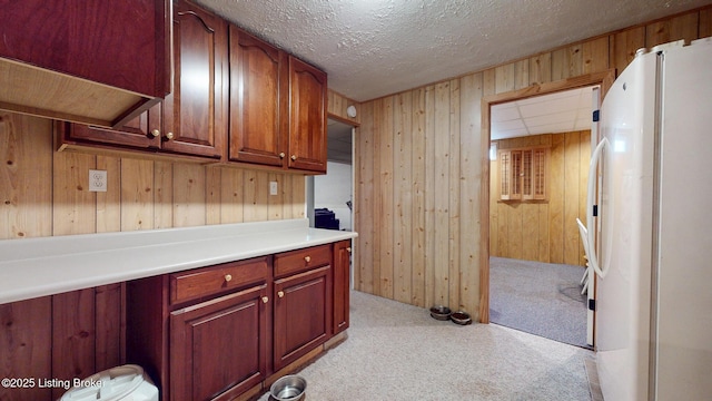 512 Valley College Dr, Louisville, KY 40272 - kitchen with freestanding refrigerator, light colored carpet, wooden walls, light countertops, and a textured ceiling