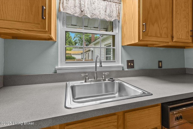 3306 Grandview Ave, Louisville, KY 40207 - kitchen featuring dishwashing machine, brown cabinetry, and dark countertops