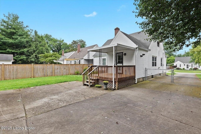 3306 Grandview Ave, Louisville, KY 40207 - view of front facade featuring a gate, a deck, a chimney, and concrete driveway