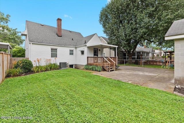 3306 Grandview Ave, Louisville, KY 40207 - back of house featuring a chimney, a patio area, and roof with shingles