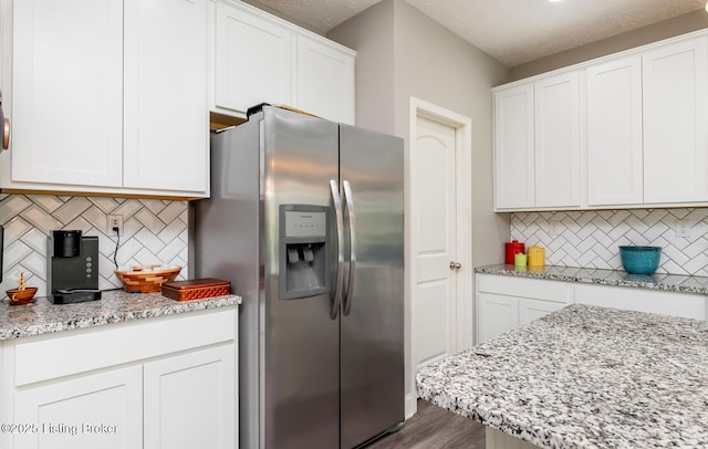 17121 Piton Way, Louisville, KY 40245 - kitchen featuring stainless steel fridge with ice dispenser, decorative backsplash, white cabinetry, and light stone countertops
