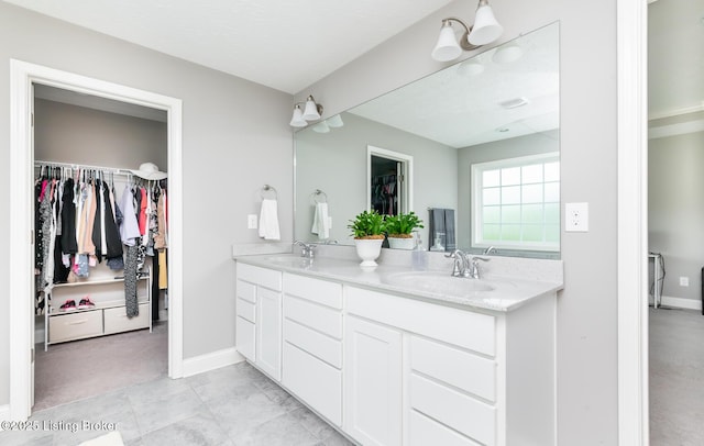 17121 Piton Way, Louisville, KY 40245 - full bathroom featuring double vanity, a spacious closet, and baseboards