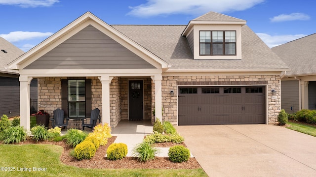 1911 Dressage Cir, Louisville, KY 40245 - view of front facade featuring driveway, roof with shingles, stone siding, and covered porch