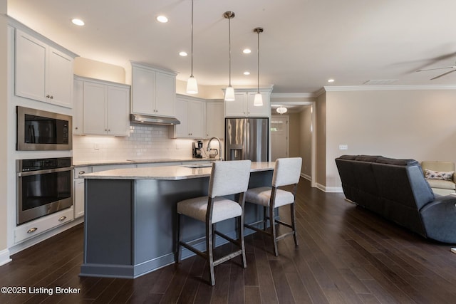 1911 Dressage Cir, Louisville, KY 40245 - kitchen with appliances with stainless steel finishes, open floor plan, a sink, a kitchen island with sink, and a breakfast bar