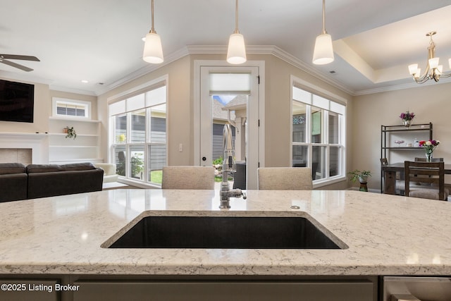 1911 Dressage Cir, Louisville, KY 40245 - kitchen featuring open floor plan, a sink, light stone counters, a chandelier, and ornamental molding