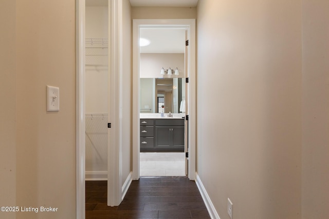 1911 Dressage Cir, Louisville, KY 40245 - corridor with dark wood-style floors, baseboards, and a sink
