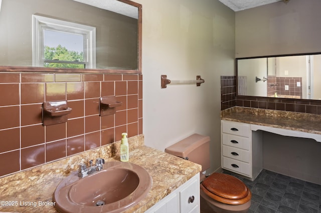 360 Pumpkin Rd, Shepherdsville, KY 40165 - bathroom with toilet, vanity, tasteful backsplash, and tile walls