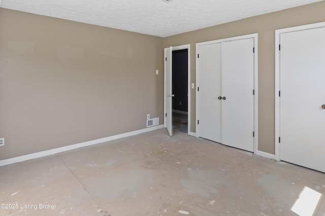 360 Pumpkin Rd, Shepherdsville, KY 40165 - unfurnished bedroom with a textured ceiling, baseboards, and multiple closets