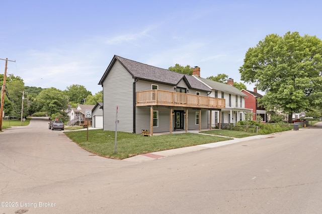 802 Kentucky Ave, Frankfort, KY 40601 - view of front of property featuring a garage, a front lawn, a wooden deck, a chimney, and driveway