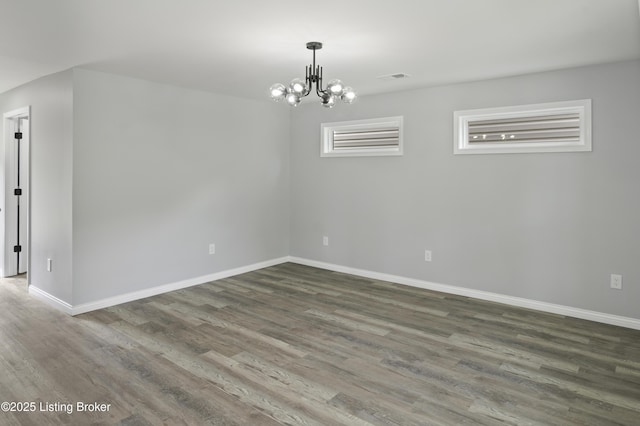 802 Kentucky Ave, Frankfort, KY 40601 - unfurnished room with wood finished floors, baseboards, and a chandelier
