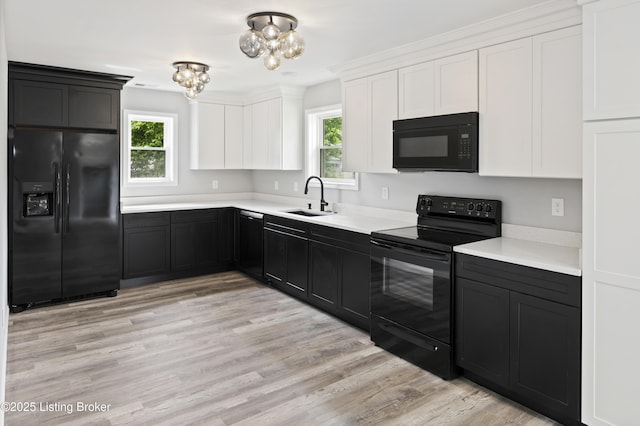 802 Kentucky Ave, Frankfort, KY 40601 - kitchen featuring black appliances, a sink, light countertops, white cabinetry, and dark cabinets