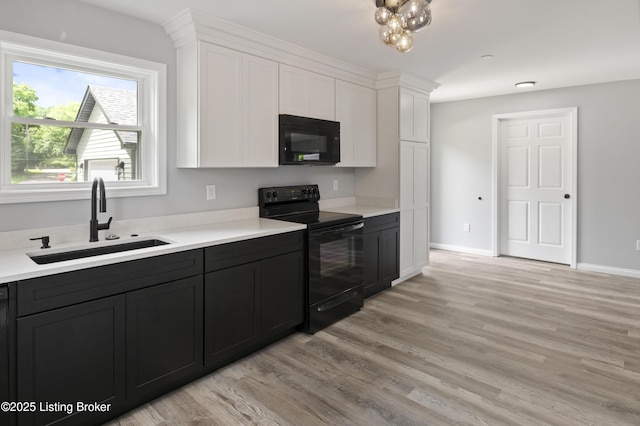 802 Kentucky Ave, Frankfort, KY 40601 - kitchen featuring black appliances, a sink, white cabinets, and light wood-style flooring