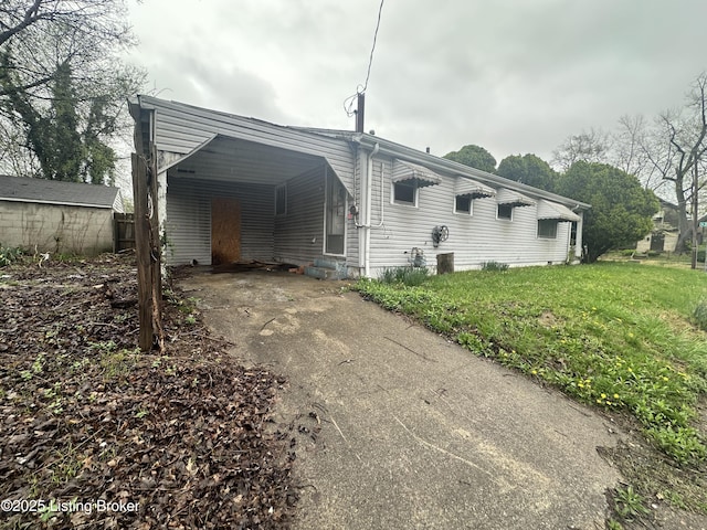 500 N 39th St, Louisville, KY 40212 - view of property exterior with asphalt driveway, an attached carport, and a yard