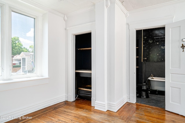 1337 S 1st St Unit 3R, Louisville, KY 40208 - unfurnished bedroom with crown molding and wood finished floors