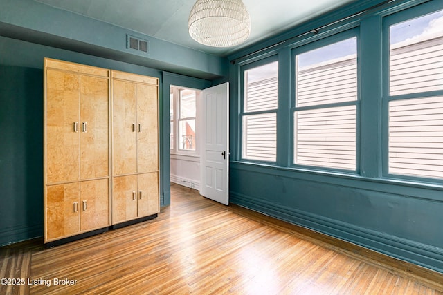 1337 S 1st St Unit 3R, Louisville, KY 40208 - unfurnished bedroom with wood finished floors