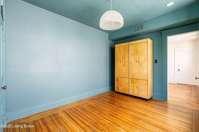 1337 S 1st St Unit 3R, Louisville, KY 40208 - unfurnished bedroom featuring baseboards and wood finished floors