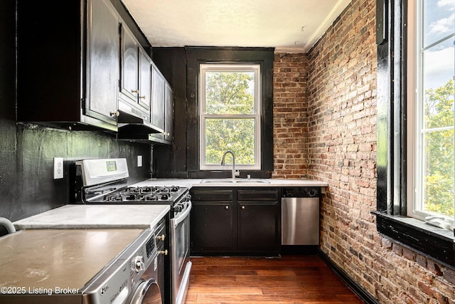 1337 S 1st St Unit 3R, Louisville, KY 40208 - kitchen featuring a sink, stainless steel appliances, dark wood-style flooring, brick wall, and light countertops